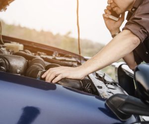 Man try to fix a car engine problem on a local road Chiang mai Thailand - people with car problem transportation concept